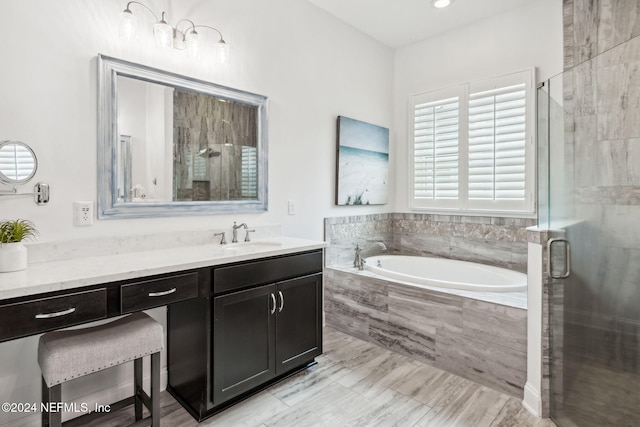 bathroom with vanity and independent shower and bath