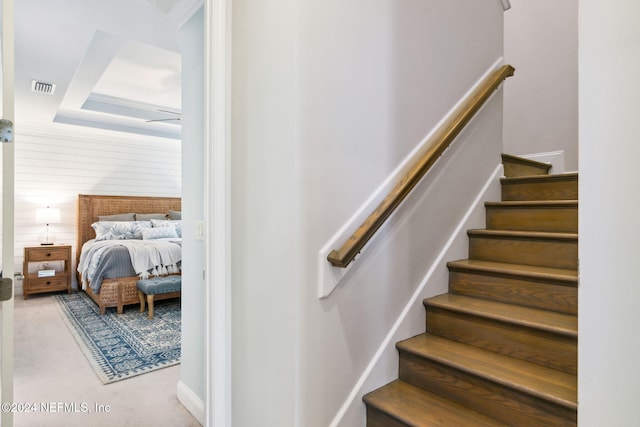 staircase with wood walls