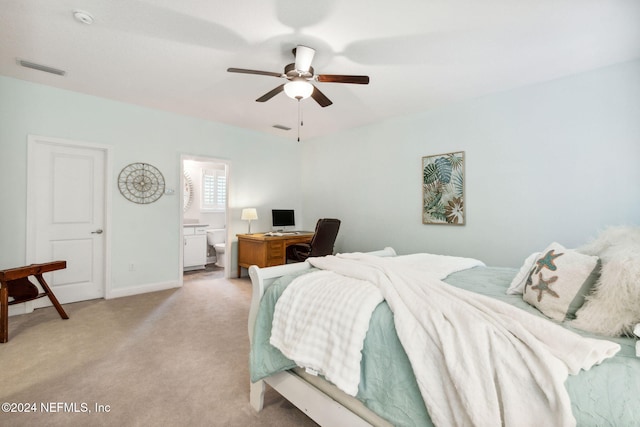 carpeted bedroom with ceiling fan and ensuite bathroom