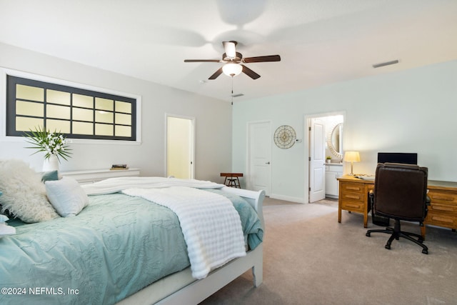 bedroom with ensuite bathroom, ceiling fan, and light colored carpet