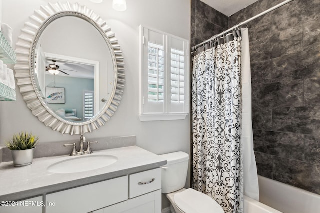 full bathroom with shower / tub combo, vanity, toilet, and ceiling fan