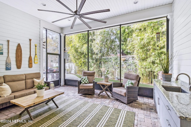 sunroom / solarium with ceiling fan and sink