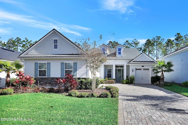 view of front of property featuring a garage and a front lawn