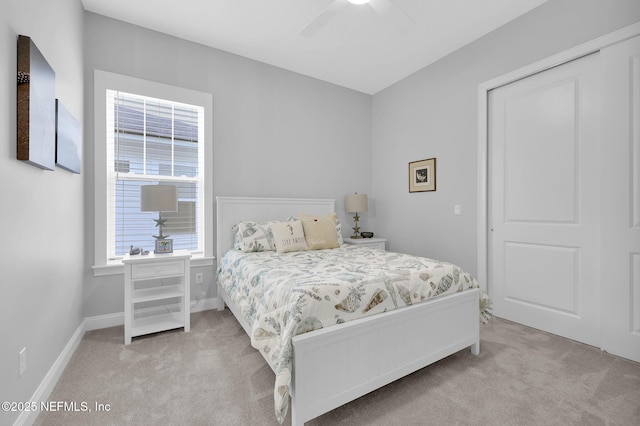 bedroom featuring a closet, ceiling fan, and light carpet