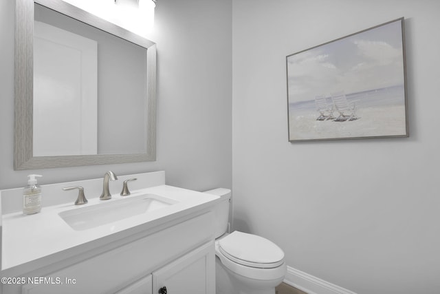 bathroom featuring toilet and vanity