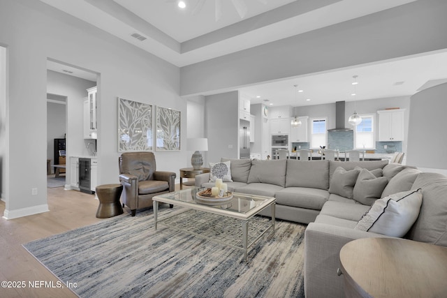 living room featuring light hardwood / wood-style flooring and wine cooler