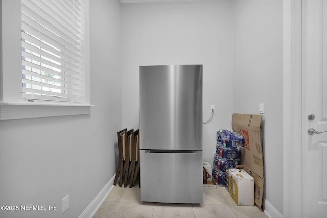 kitchen with stainless steel refrigerator and light tile patterned floors