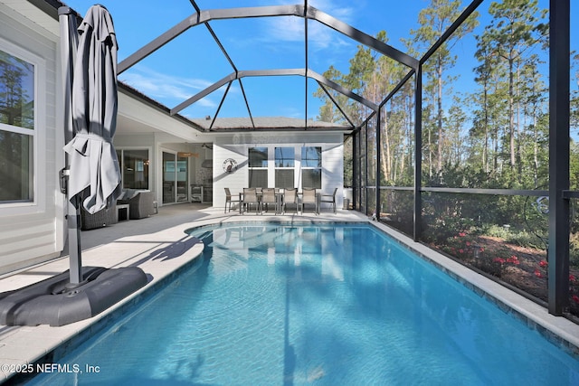 view of pool with a patio area and a lanai