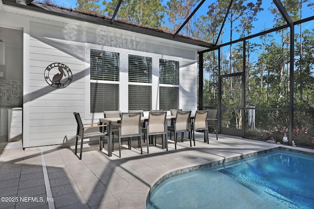 view of swimming pool with a patio area and a lanai