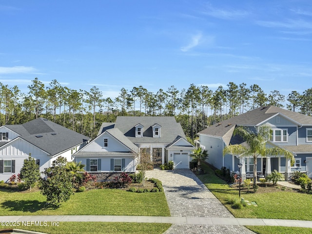 view of front of house with a front yard and a garage