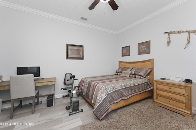 bedroom with ceiling fan, light hardwood / wood-style floors, a textured ceiling, and ornamental molding