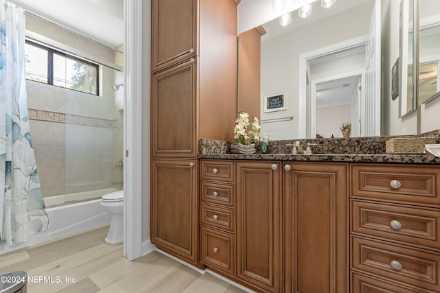 full bathroom with vanity, hardwood / wood-style floors, shower / bathtub combination with curtain, and toilet