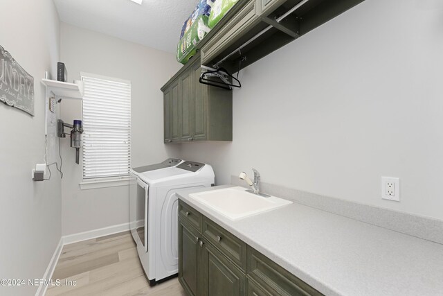 101 Montura Dr, Ponte Vedra Beach, FL 32082 - laundry room with cabinet space, washer and dryer, and light wood finished floors