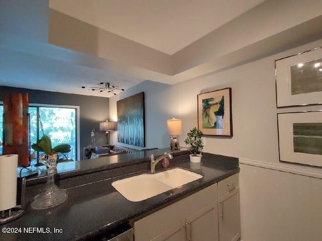 kitchen featuring white cabinetry, sink, oven, and ceiling fan