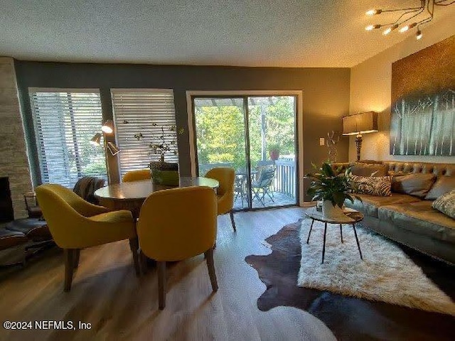 living room with plenty of natural light, a textured ceiling, and hardwood / wood-style flooring