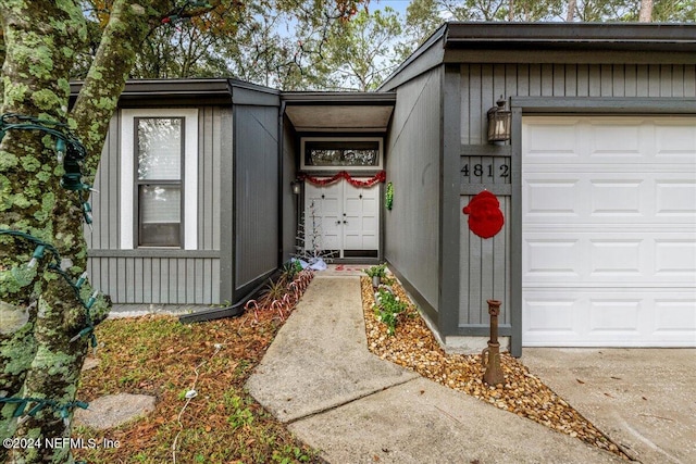 doorway to property with a garage