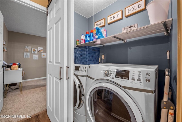 laundry area featuring washer and dryer and a textured ceiling