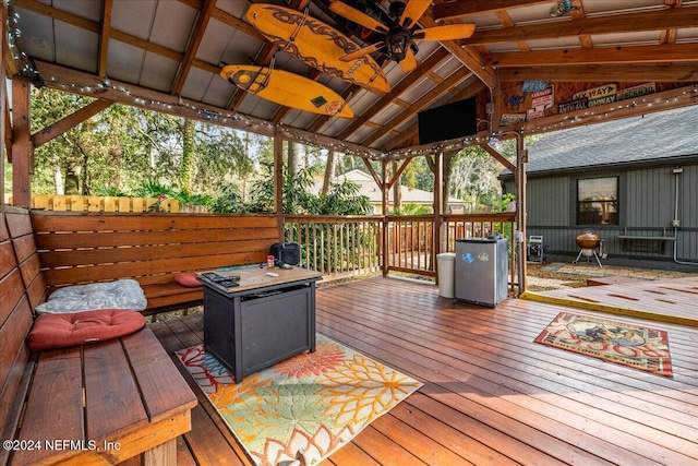 wooden deck featuring a gazebo and ceiling fan