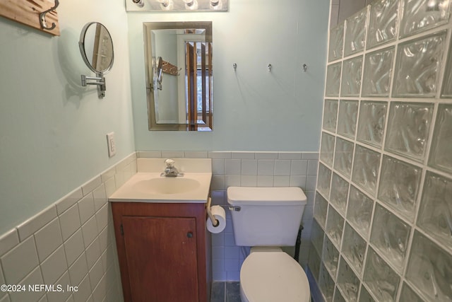 3145 Coastal Hwy Unit 1138, Saint Augustine, FL 32084 - bathroom featuring vanity, toilet, and tile walls