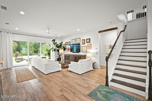 living room with ceiling fan and light wood-type flooring