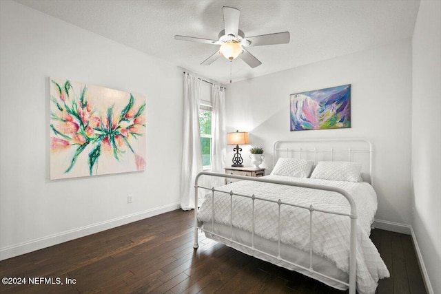 bedroom featuring a textured ceiling, ceiling fan, and dark wood-type flooring