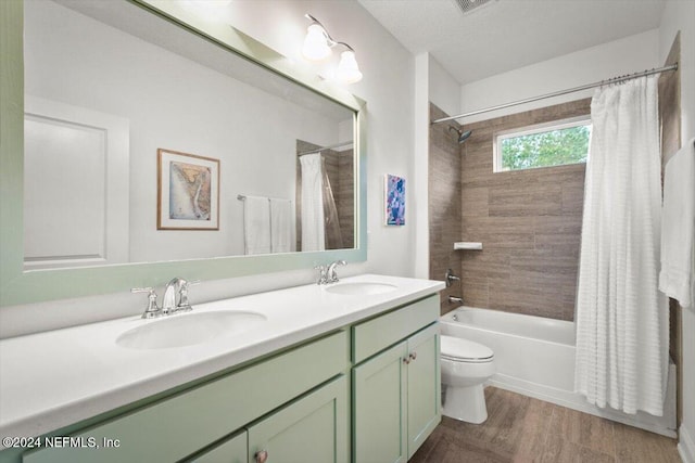 full bathroom with toilet, shower / bath combo with shower curtain, vanity, and hardwood / wood-style flooring