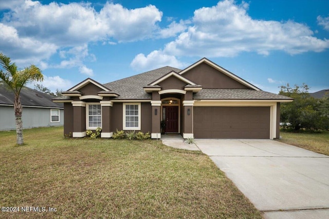 ranch-style home with a front yard, roof with shingles, stucco siding, a garage, and driveway