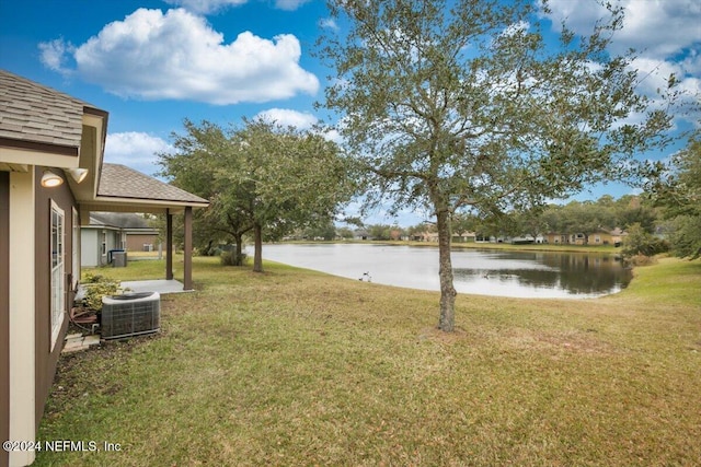 view of yard featuring a water view and central AC