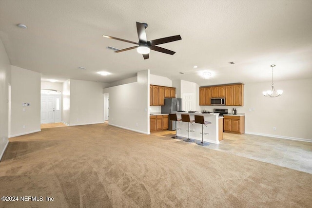 unfurnished living room featuring light carpet and ceiling fan with notable chandelier