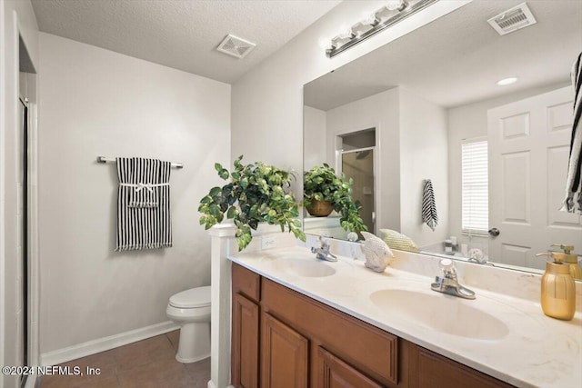 bathroom with tile patterned floors, visible vents, and a sink