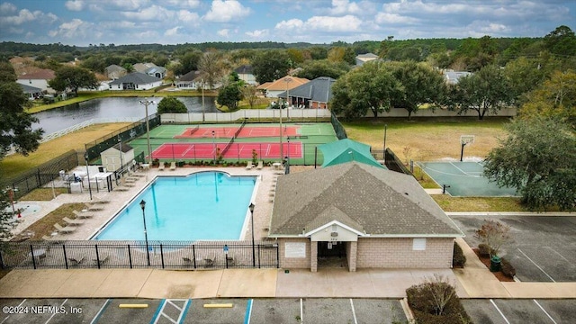 view of swimming pool featuring a water view