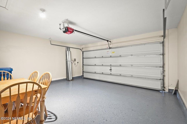 garage with a garage door opener and baseboards