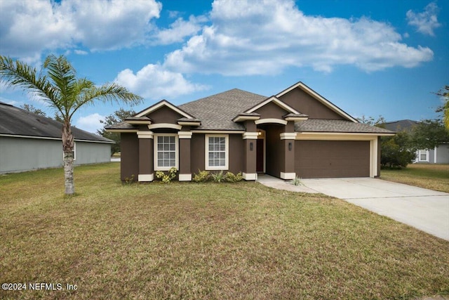 single story home with stucco siding, driveway, a front yard, and an attached garage