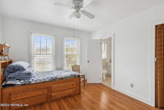 bedroom with hardwood / wood-style flooring, ceiling fan, and connected bathroom