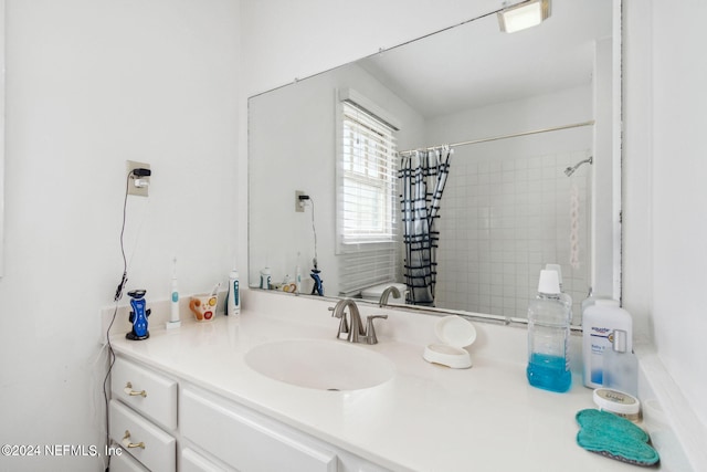 bathroom with a shower with curtain and vanity