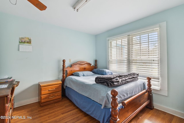 bedroom with hardwood / wood-style floors and ceiling fan