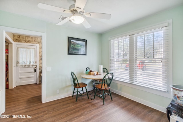 dining area featuring ceiling fan and dark hardwood / wood-style floors