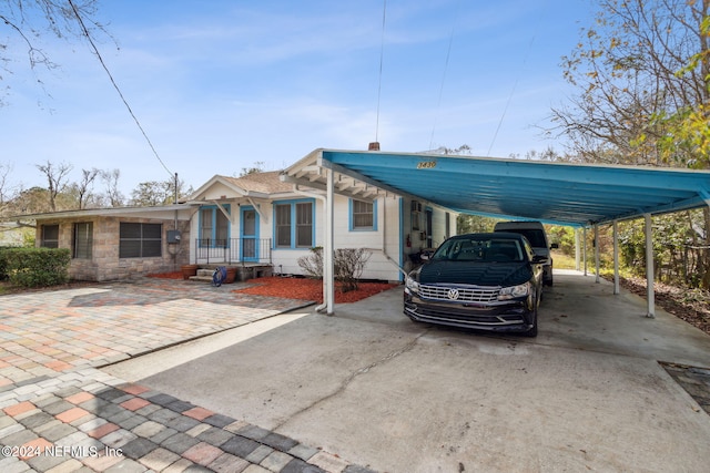 manufactured / mobile home featuring a porch and a carport