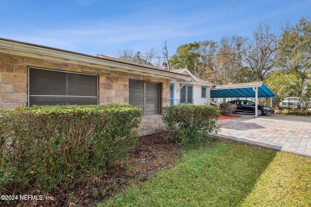 view of home's exterior featuring a carport