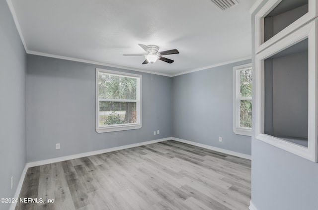 spare room featuring light hardwood / wood-style floors, ceiling fan, and crown molding