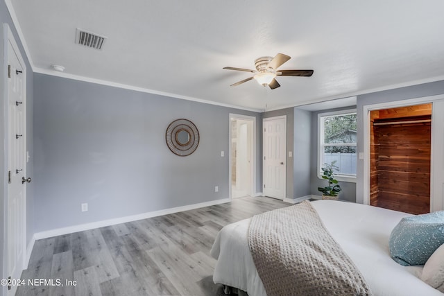 bedroom with light hardwood / wood-style floors, ceiling fan, and ornamental molding