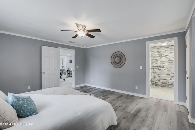 bedroom featuring ceiling fan, crown molding, and wood-type flooring