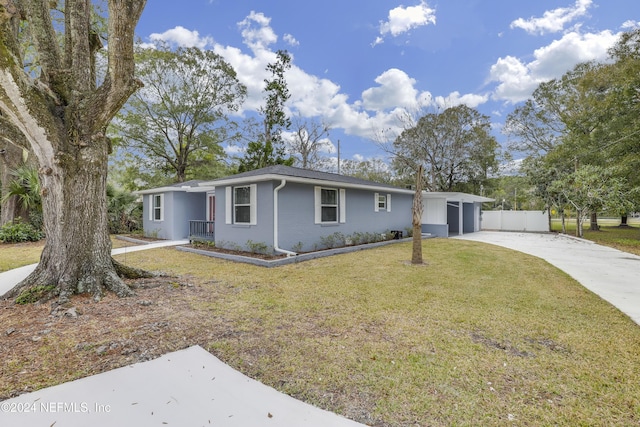 single story home featuring a front yard and a garage