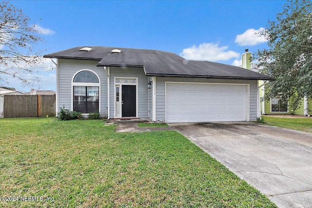 view of front facade featuring a front yard and a garage