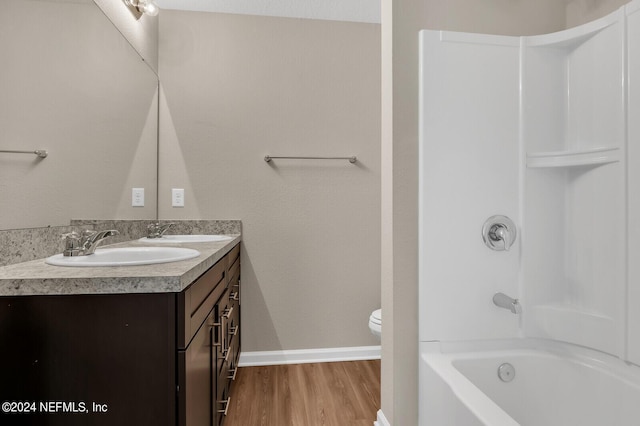 full bathroom with vanity, wood-type flooring, bathtub / shower combination, and toilet