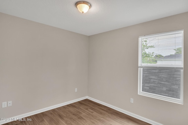 empty room with hardwood / wood-style floors