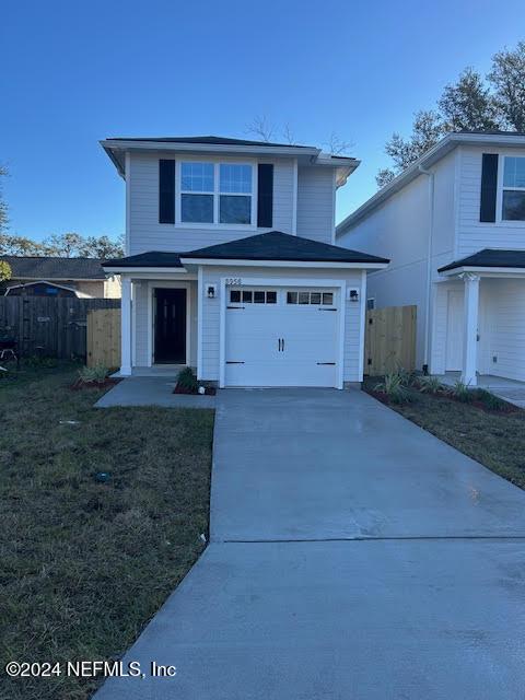 front facade with a front yard and a garage