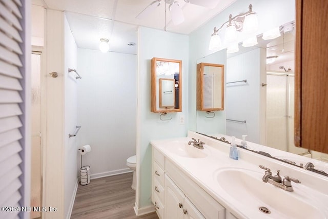 bathroom featuring hardwood / wood-style floors, ceiling fan, toilet, and vanity