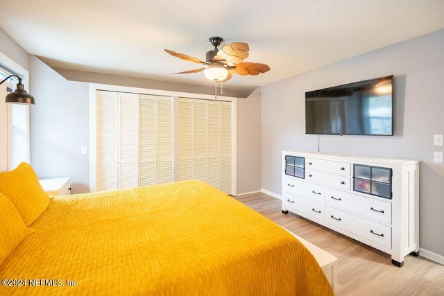 unfurnished bedroom with a textured ceiling, light hardwood / wood-style flooring, and ceiling fan