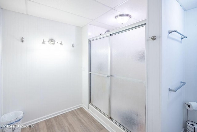 bathroom featuring hardwood / wood-style floors and a shower with door